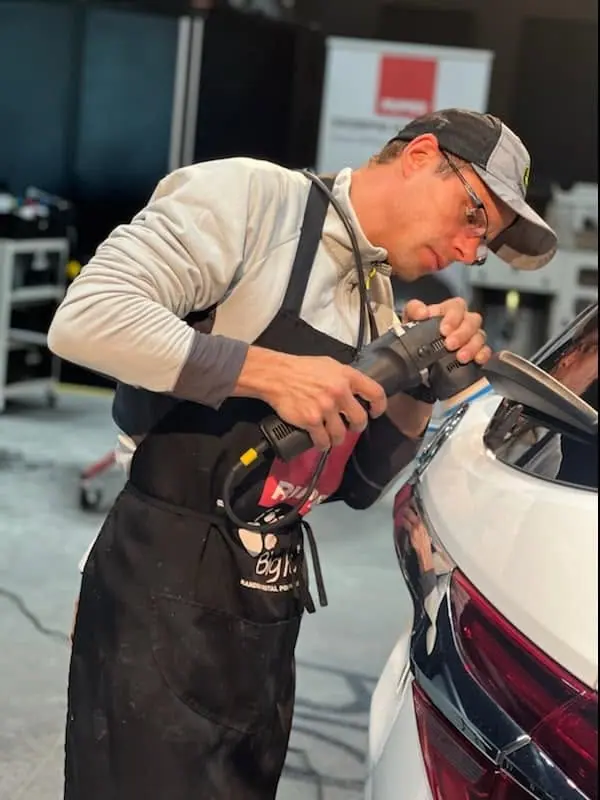 David Kontje machine-polishing the paint on a white car