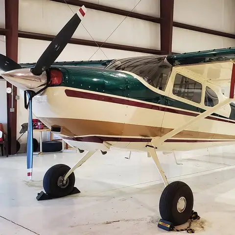 Single-engine airplane being detailed in a hangar