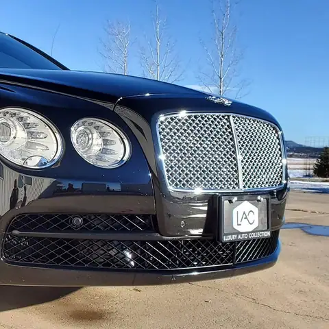 Black Bentley sedan with a mirror finish after detailing