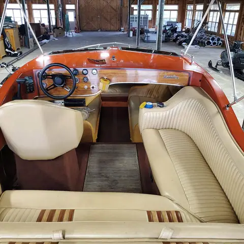 Cream vinyl interior of a classic wood-trimmed boat after cleaning