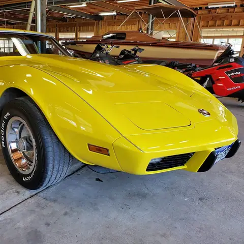 Yellow C3 Corvette detailed in a garage