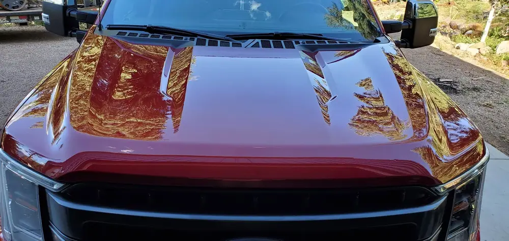 Glossy red hood of a Ford F-150 after detailing
