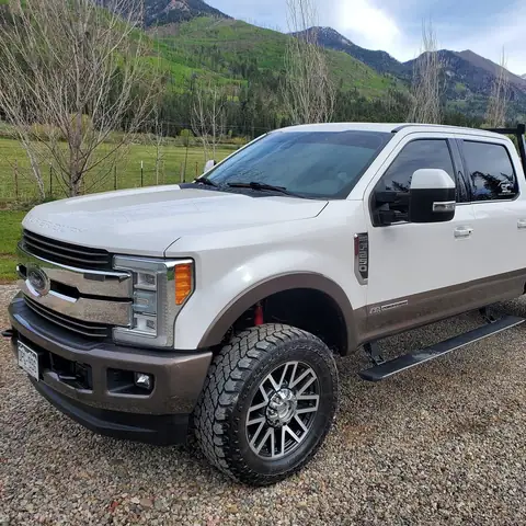 White Ford F-250 Super Duty after a mobile detail, with the San Juan Mountains behind it