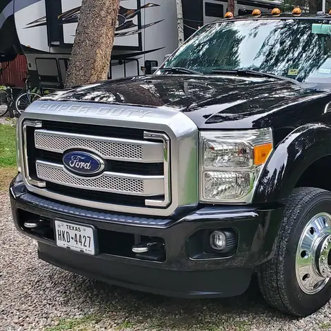 Black Ford F-350 dually pickup with glossy paint after detailing