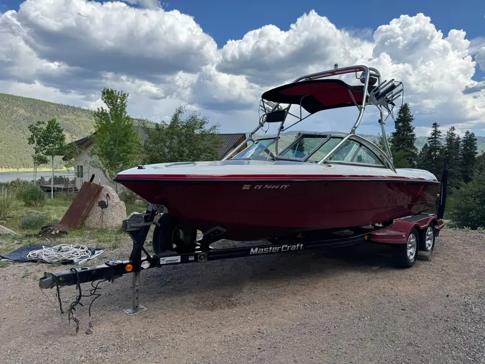Red MasterCraft wake boat on its trailer after a full exterior detail